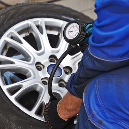 Tyre replacement in Wimbledon, mechanic checking pressure